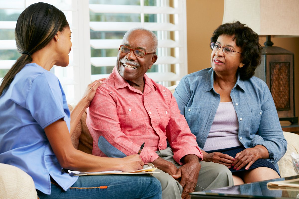 Caregiver consulting with elderly couple